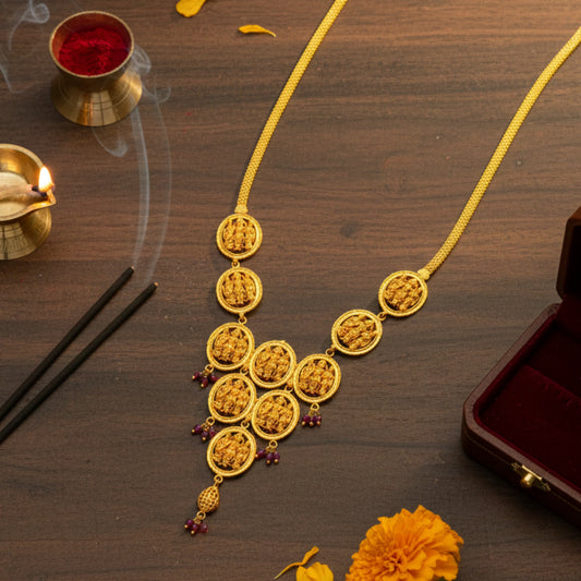 Gold plated Ayodhya Heritage Ram Parivar necklace on a wooden surface with candles and flowers