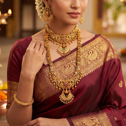 A rare collector's bridal set featuring an exquisite, intricately carved Chandbali (crescent) motif rarely seen in traditional South Indian matte temple jewelry layout configurations. Comes with a long haram, a short haram or choker and complimented with a chandbali earrings set