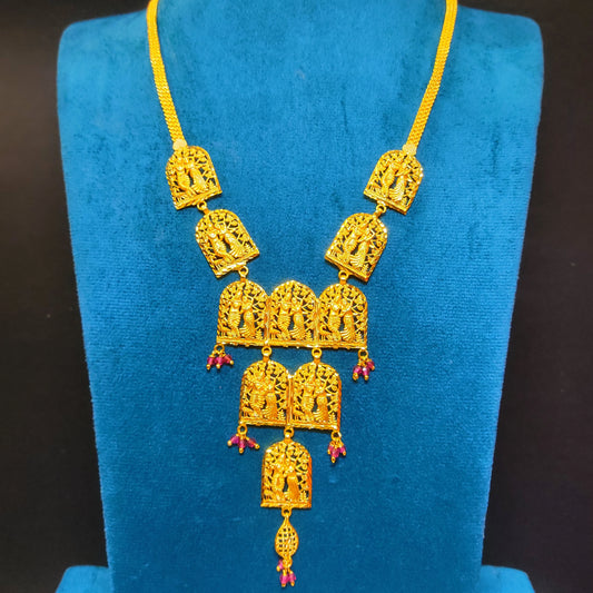 Gold plated Vrindavan Heritage Radha Krishna necklace on a blue velvet stand with a dark background