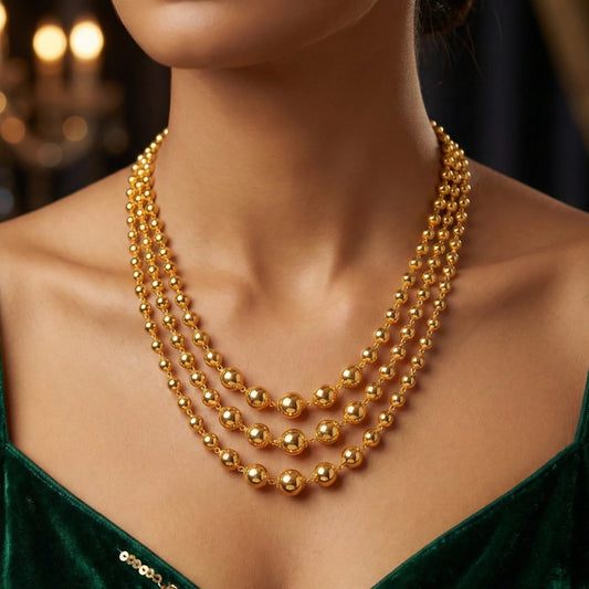 Gold plated necklace on a model with a blurred candlelit background