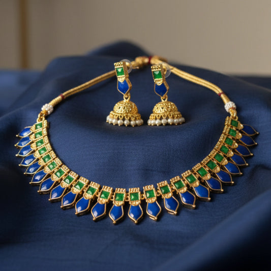 Antique gold finish Jewelry set with necklace and earrings on a blue fabric background