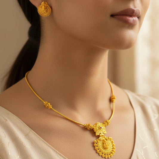 Antique Gold Finish necklace and earrings on a model against a neutral background